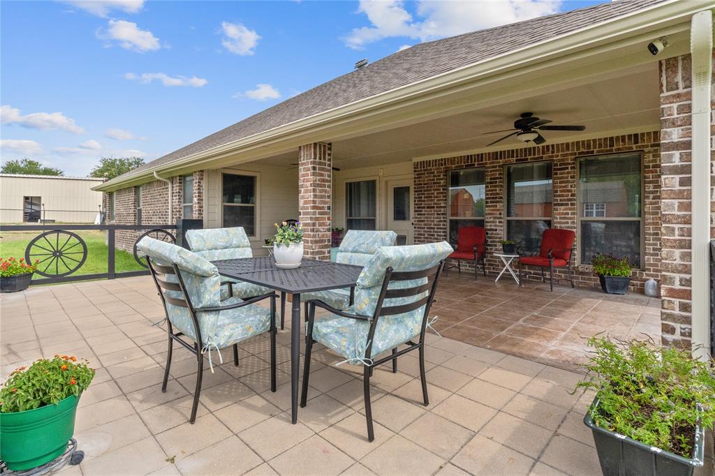 5965 Feather Wind Way Fort Worth, TX 76135 - Photo 27 of 35 a view of a patio with table and chairs and potted plants