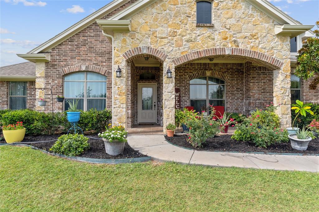 5965 Feather Wind Way Fort Worth, TX 76135 - Photo 5 of 35 a front view of a house with a garden
