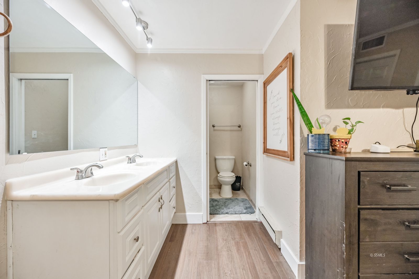 1407 North Indian Wells Street Ridgecrest, CA 93555 - Photo 37 of 50 a bathroom with a sink a mirror and a toilet