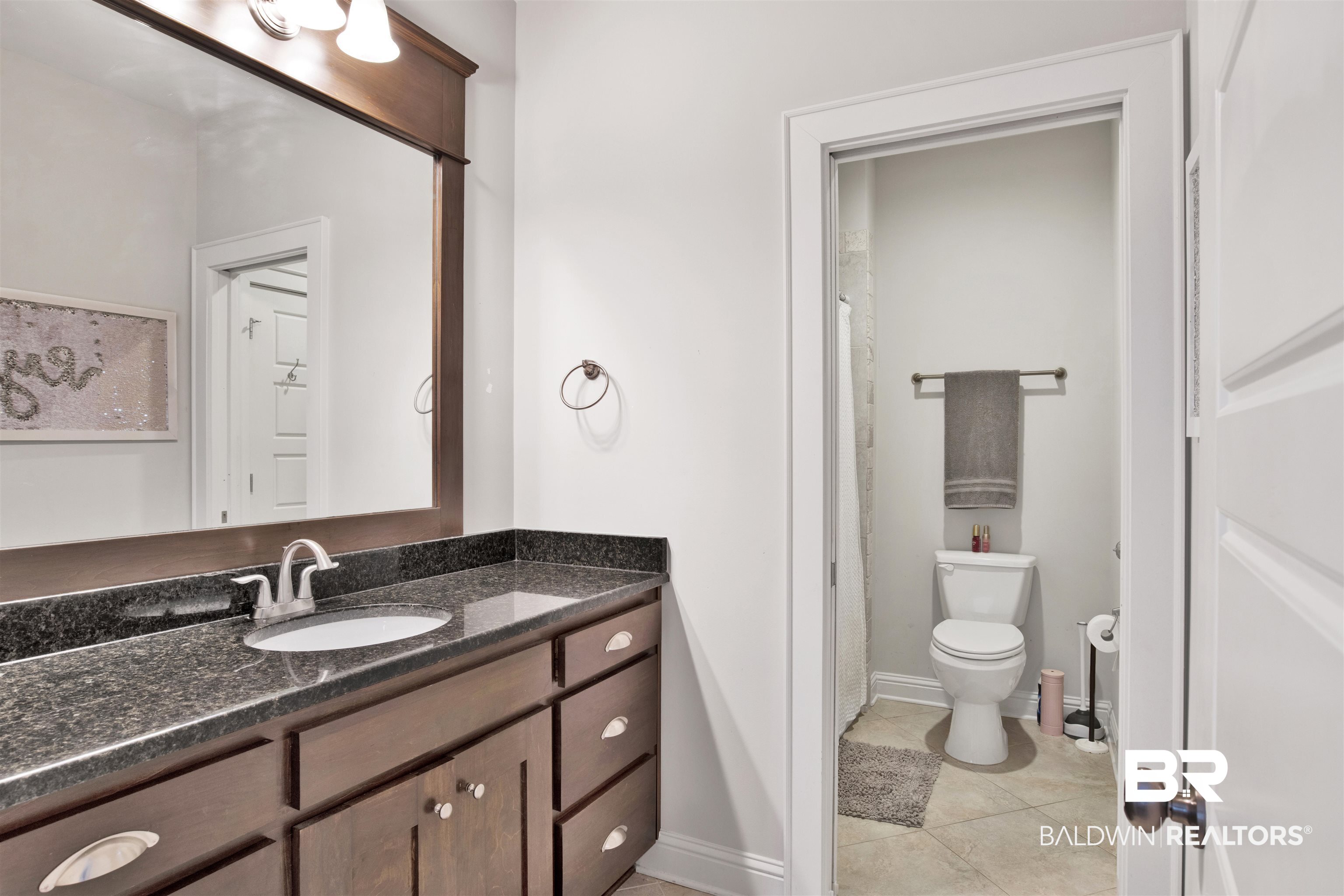11244 Redfern Road Daphne, AL 36526 - Photo 42 of 50 Bathroom featuring tile patterned floors, vanity, and toilet