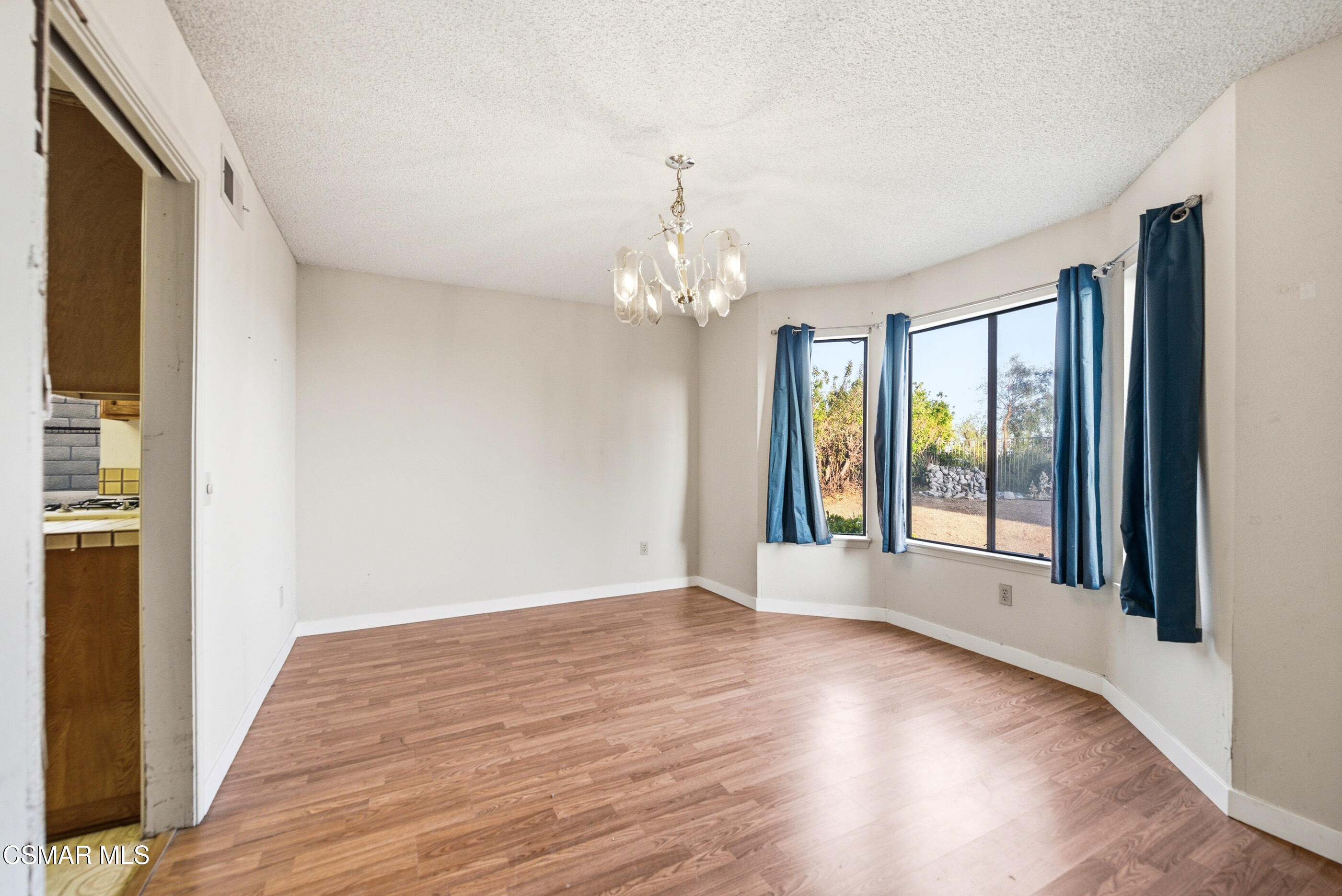 12036 Shadow Ridge Way Porter Ranch, CA 91326 - Photo 16 of 35 a view of an empty room with wooden floor and a window