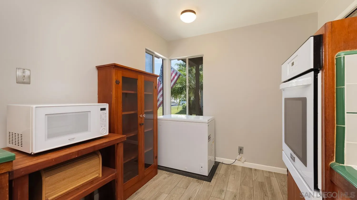 1003 Tiger Tail Road Vista, CA 92084 - Photo 13 of 22 a view of an empty room with wooden floor and a window
