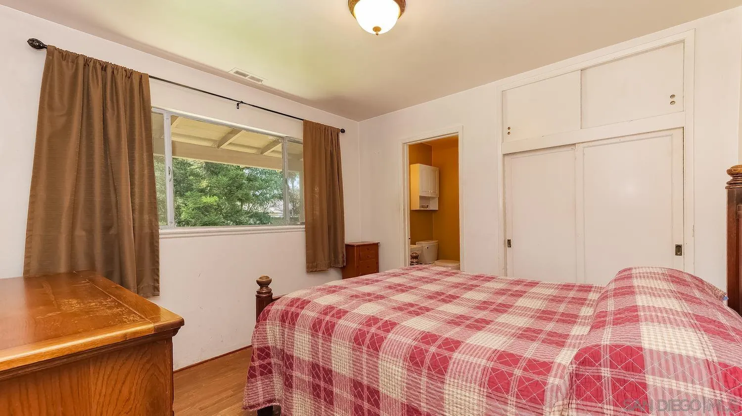 1003 Tiger Tail Road Vista, CA 92084 - Photo 14 of 22 a bedroom with a bed and a window
