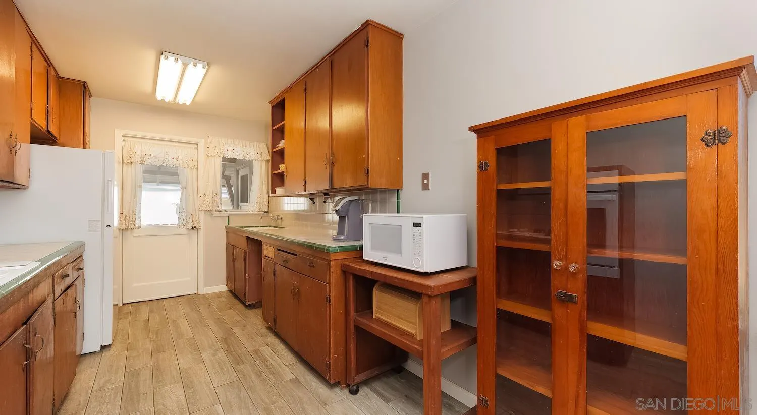1003 Tiger Tail Road Vista, CA 92084 - Photo 9 of 22 a kitchen with a sink cabinets and wooden floor