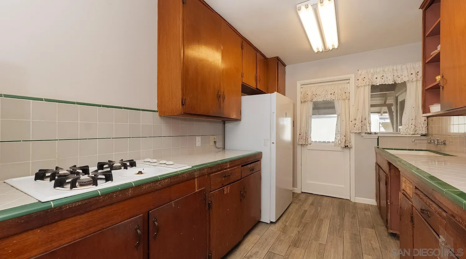 1003 Tiger Tail Road Vista, CA 92084 - Photo 10 of 22 a kitchen with a sink and cabinets