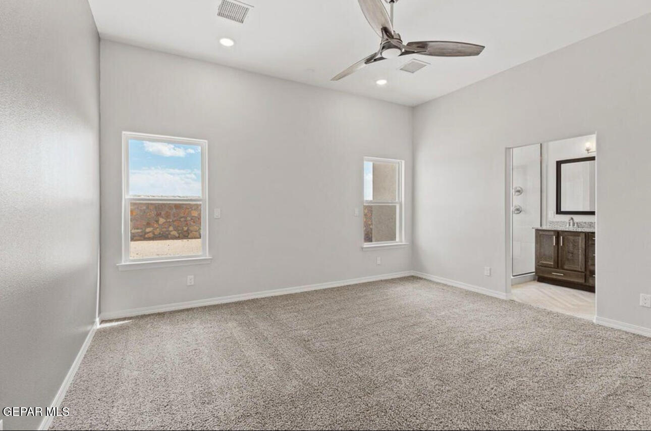 6044 Summer Ridge Street Sunland Park, NM 88008 - Photo 11 of 12 an empty room with windows and cabinet