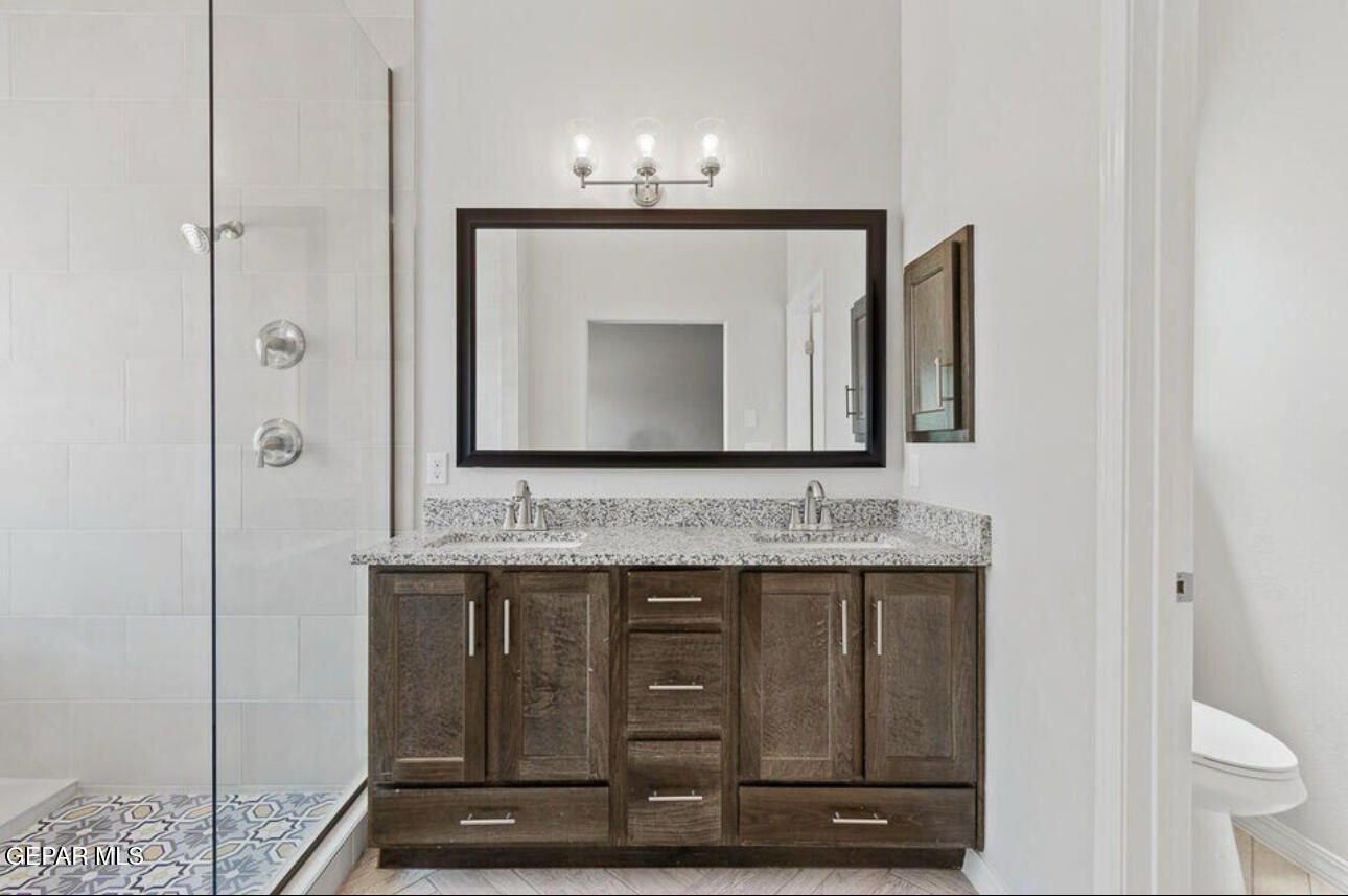 6044 Summer Ridge Street Sunland Park, NM 88008 - Photo 12 of 12 a bathroom with a toilet sink and mirror