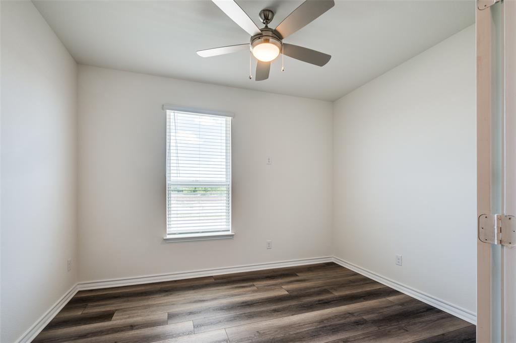 348 Fallbrook Drive Aledo, TX 76008 - Photo 11 of 31 an empty room with a window and ceiling fan