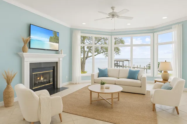 a living room with furniture large window and a fireplace