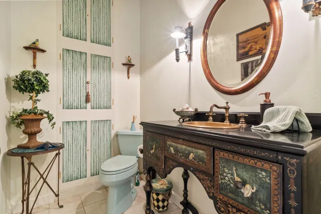 a bathroom with a toilet a sink and a mirror