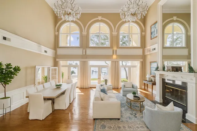 a living room with fireplace furniture and a large window