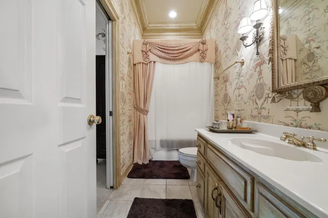 a bathroom with a sink a toilet and a shower