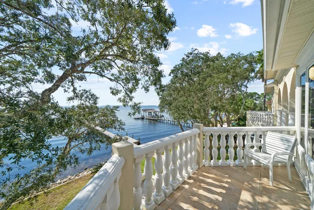 a view of balcony with wooden floor and fence