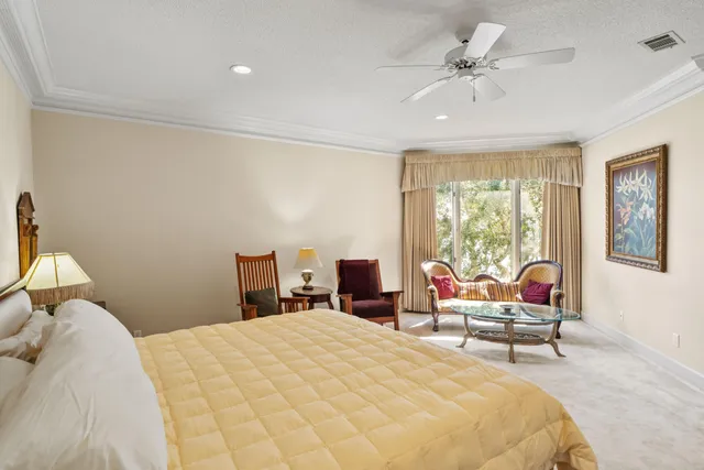 a bedroom with a bed chair and window