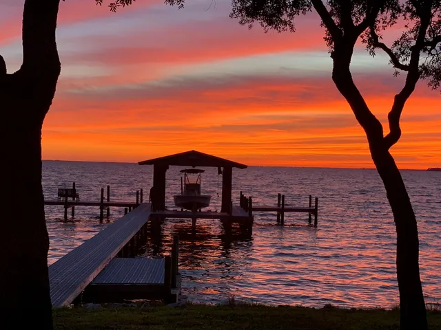 a view of a terrace with chairs and wooden fence