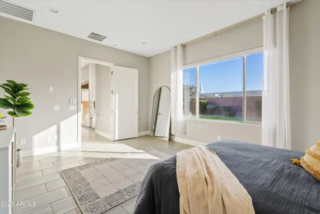 a bedroom with a bed and a window