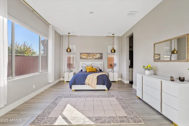 a spacious bedroom with a bed and a window