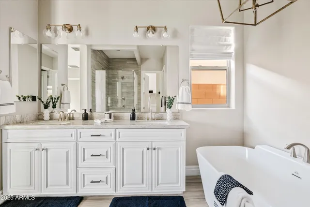 a spacious bathroom with a double vanity sink a mirror and shower