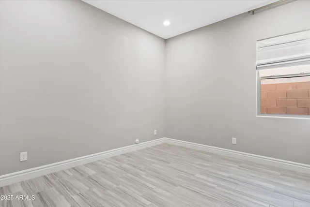 a bathroom with a granite countertop sink a toilet and a mirror