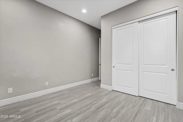 a view of a livingroom with wooden floor and window