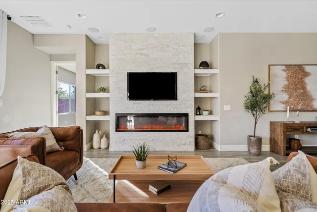 a living room with fireplace furniture and a flat screen tv