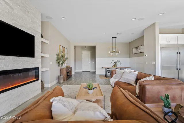 a living room with furniture a fireplace and a flat screen tv