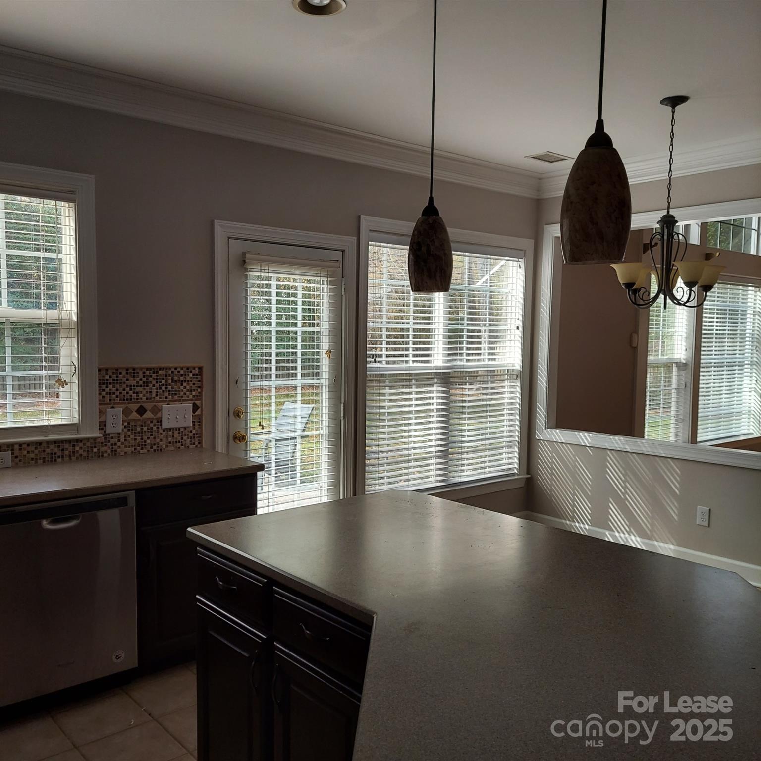10820 Knight Castle Drive Charlotte, NC 28277 - Photo 14 of 35 a open kitchen with stainless steel appliances granite countertop a stove a sink a window and a dining table