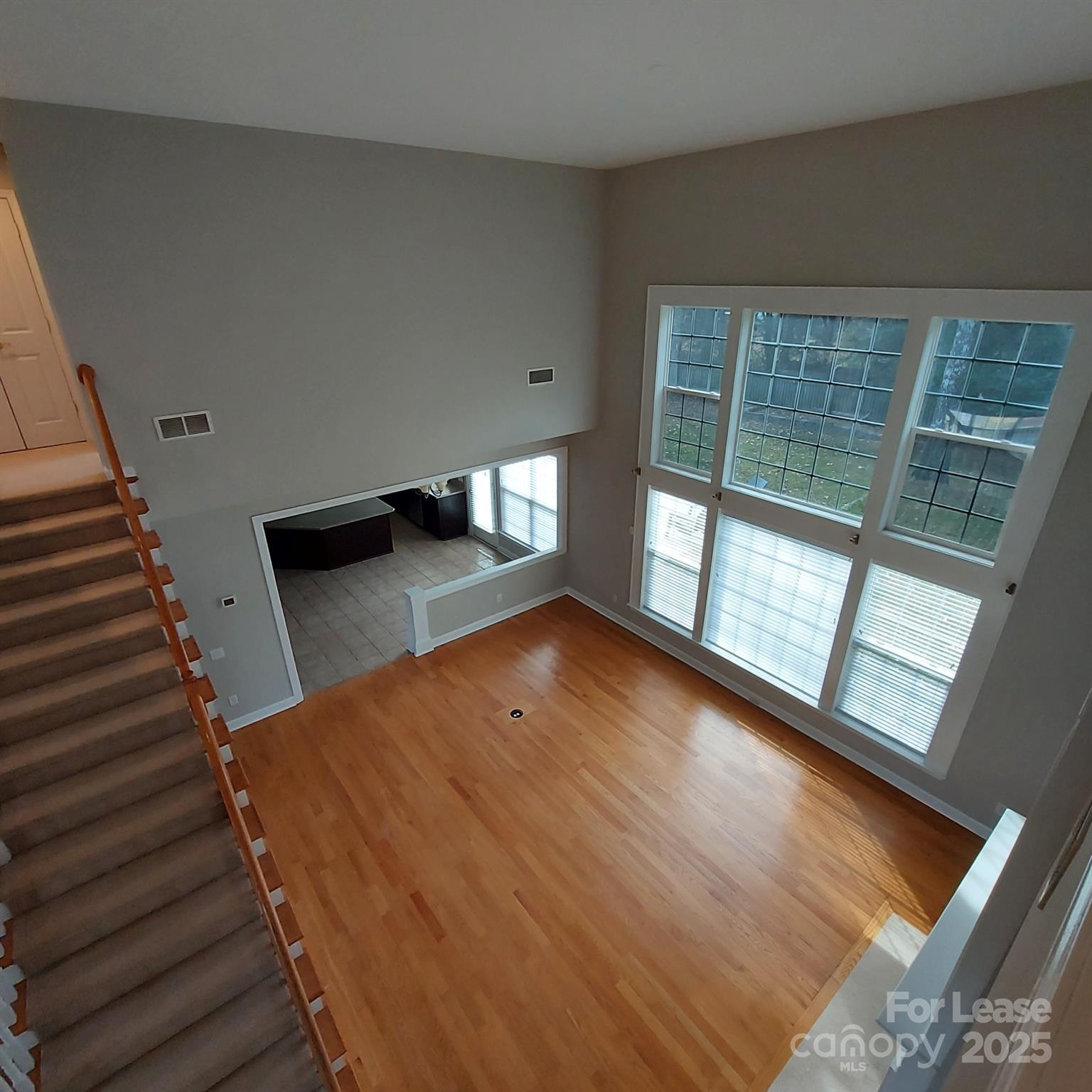 10820 Knight Castle Drive Charlotte, NC 28277 - Photo 18 of 35 a view of an empty room with wooden floor and windows