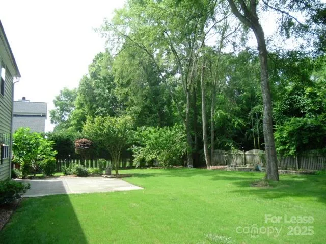 a front view of a house with a garden and yard