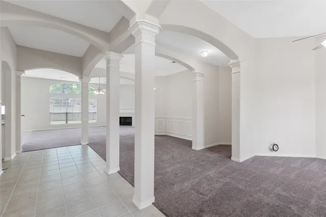 a view of a big room with windows and entryway