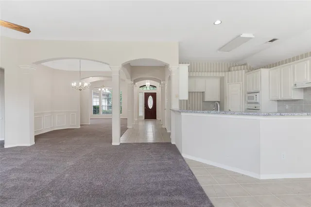 a view of a hallway to the kitchen