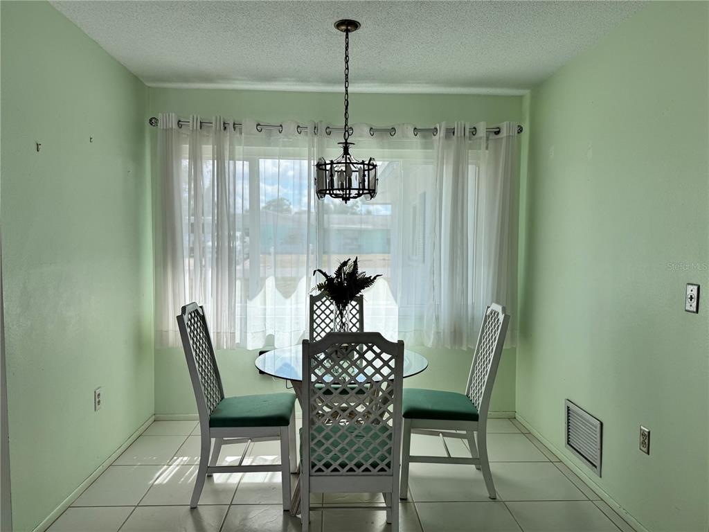 1048 Porpoise Road Venice, FL 34293 - Photo 13 of 26 a view of a dining room with furniture and chandelier