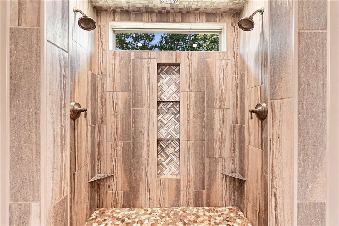 181 Sentell Road Williamston, SC 29697 - Photo 10 of 46 Floor-to-ceiling tilework and dual showerheads create a luxurious, spa-like experience.