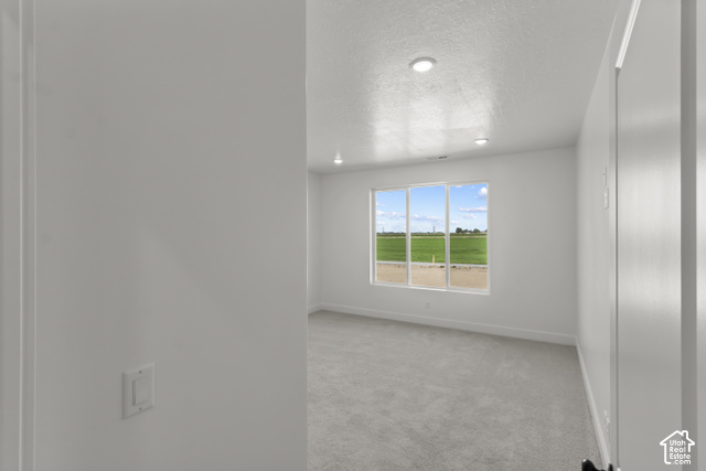 205 East 690th Street North Logan, UT 84321 - Photo 40 of 52 Recessed lighting, large window with expansive outdoor scenery, light gray carpeting, and white walls