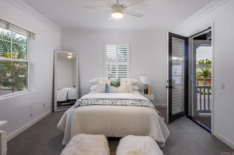 a spacious bedroom with a bed and a window