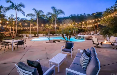 a view of a patio with swimming pool and furniture