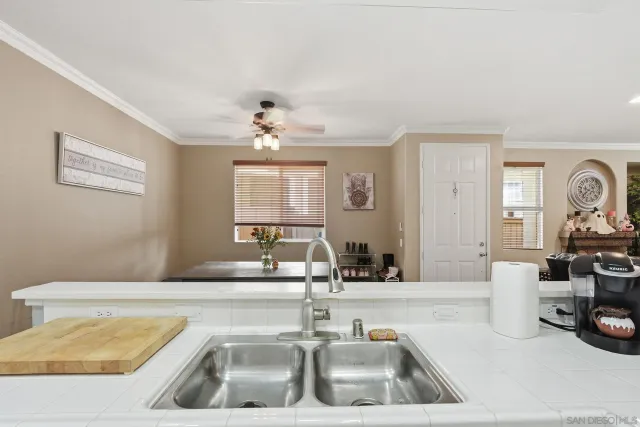 a kitchen with a sink and a mirror