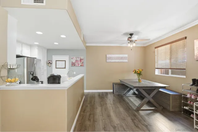 a kitchen with stainless steel appliances kitchen island hardwood floor sink stove and refrigerator