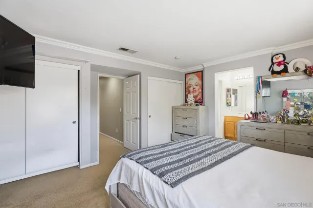 a bedroom with a bed and a television