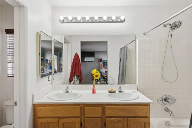 a bathroom with a double vanity sink and a mirror