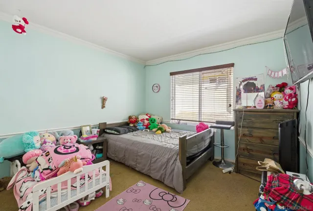 a bedroom with bed and a window