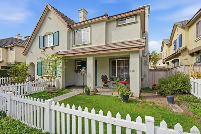 a front view of a house with a yard table and chairs