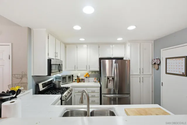 a kitchen with a refrigerator and a sink