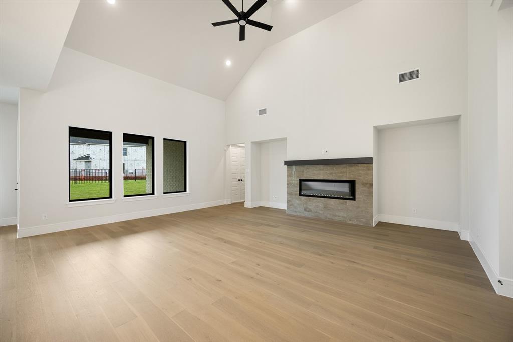207 Links Court Heath, TX 75126 - Photo 11 of 39 a view of an empty room with a fireplace and a window