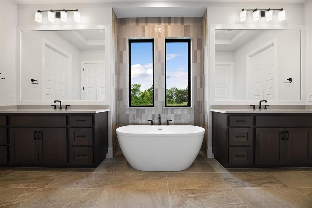 207 Links Court Heath, TX 75126 - Photo 16 of 39 a spacious bathroom with a double vanity sink double mirror and bathtub