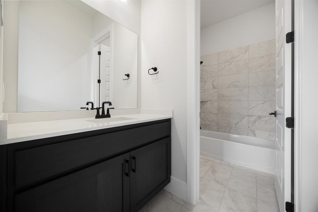 207 Links Court Heath, TX 75126 - Photo 21 of 39 a bathroom with a bathtub sink and mirror