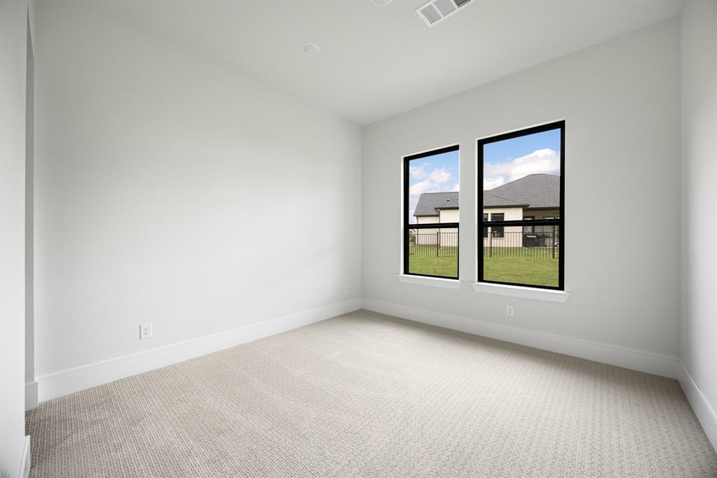 207 Links Court Heath, TX 75126 - Photo 22 of 39 an empty room with windows and closet