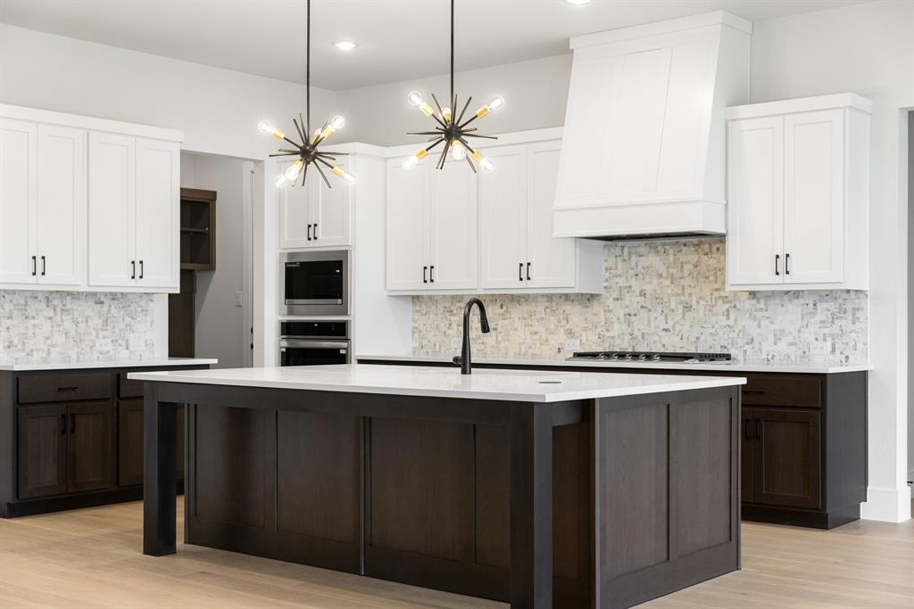 207 Links Court Heath, TX 75126 - Photo 23 of 39 a kitchen with stainless steel appliances granite countertop a sink a stove and cabinets