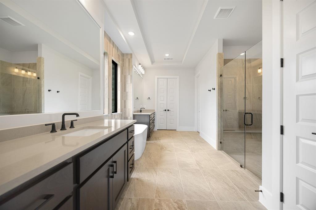 207 Links Court Heath, TX 75126 - Photo 24 of 39 a spacious bathroom with a granite countertop sink mirror and shower