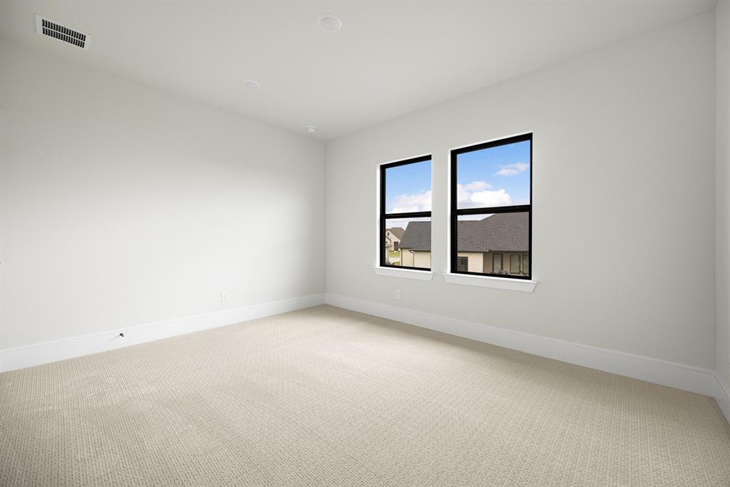 207 Links Court Heath, TX 75126 - Photo 30 of 39 an empty room with windows and closet